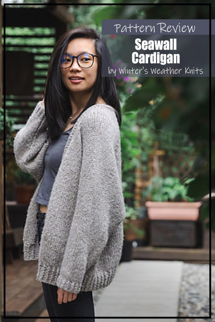 Seawall Cardigan by Winter's Weather Knits knitting pattern sample is a great oversized cardigan modeled by a woman with long black hair standing outside on a porch or patio