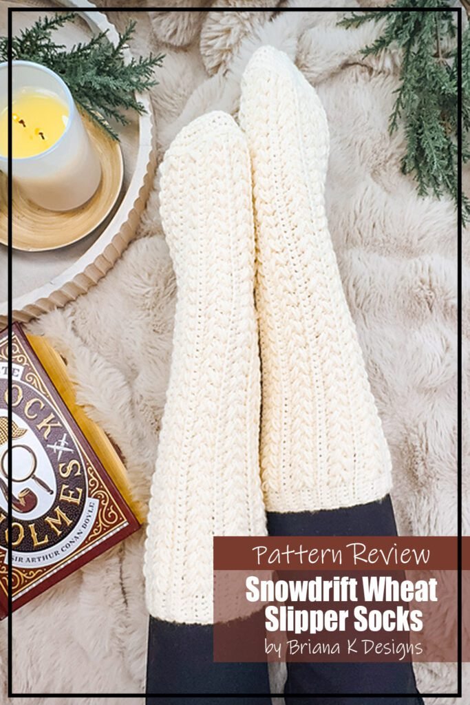 Snowdrift Wheat Slipper Socks crochet pattern sample is modeled by a person wearing black leggings with the cream coloured slipper socks over top. The text reads "Snowdrift Wheat Slipper Socks by Briana K Designs Pattern Review."
