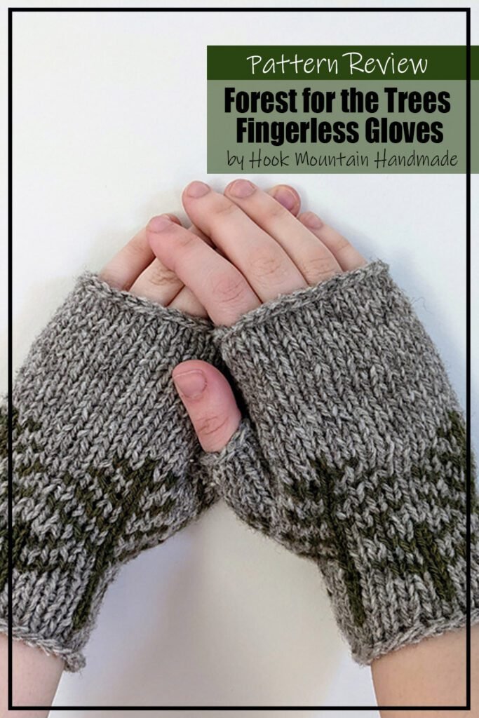 knit sample of the pattern "Forest For The Trees Fingerless Gloves" by Hook Mountain Handmade.  The sample is knit with grey wool and the main colour and a tree motif knit in green.  The fingerless mitts are modeled on hands.