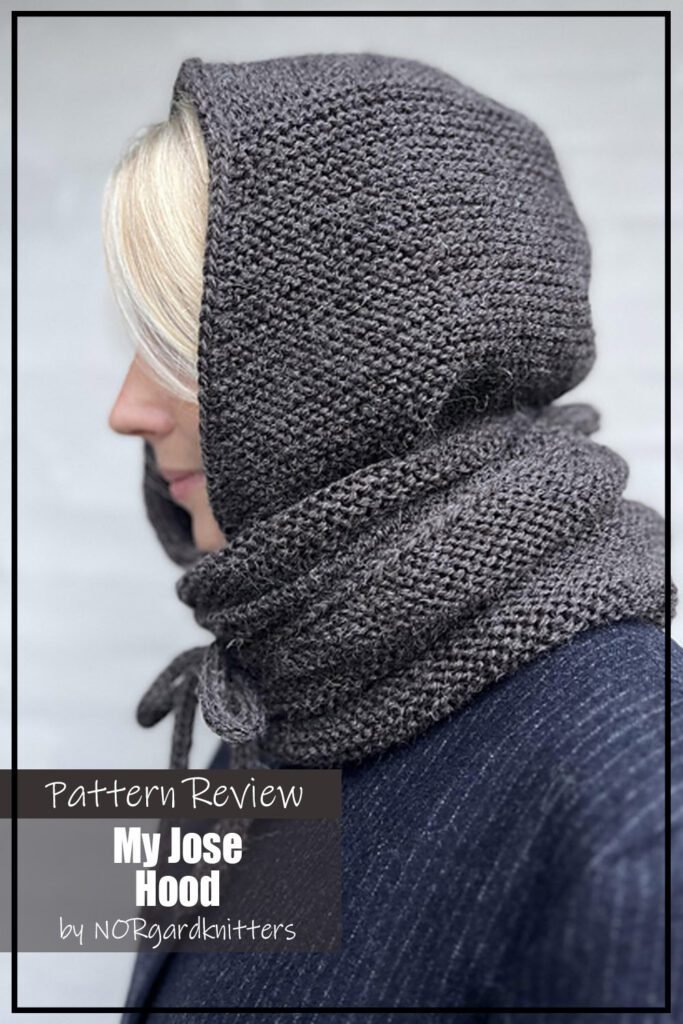 My Jose Hood scarf knitting pattern sample is made using a dark grey yarn. It is model by a woman with blond hair wearing a dark blue coat. The text on the image reads "My Jose Hood by NORgardknitters Pattern Review".